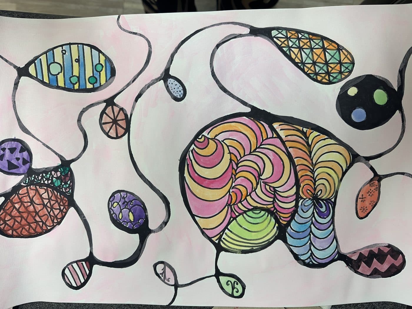 A marker drawing of connected bubbles and pods, each filled with a different pattern of stripes, dots, and zigzags